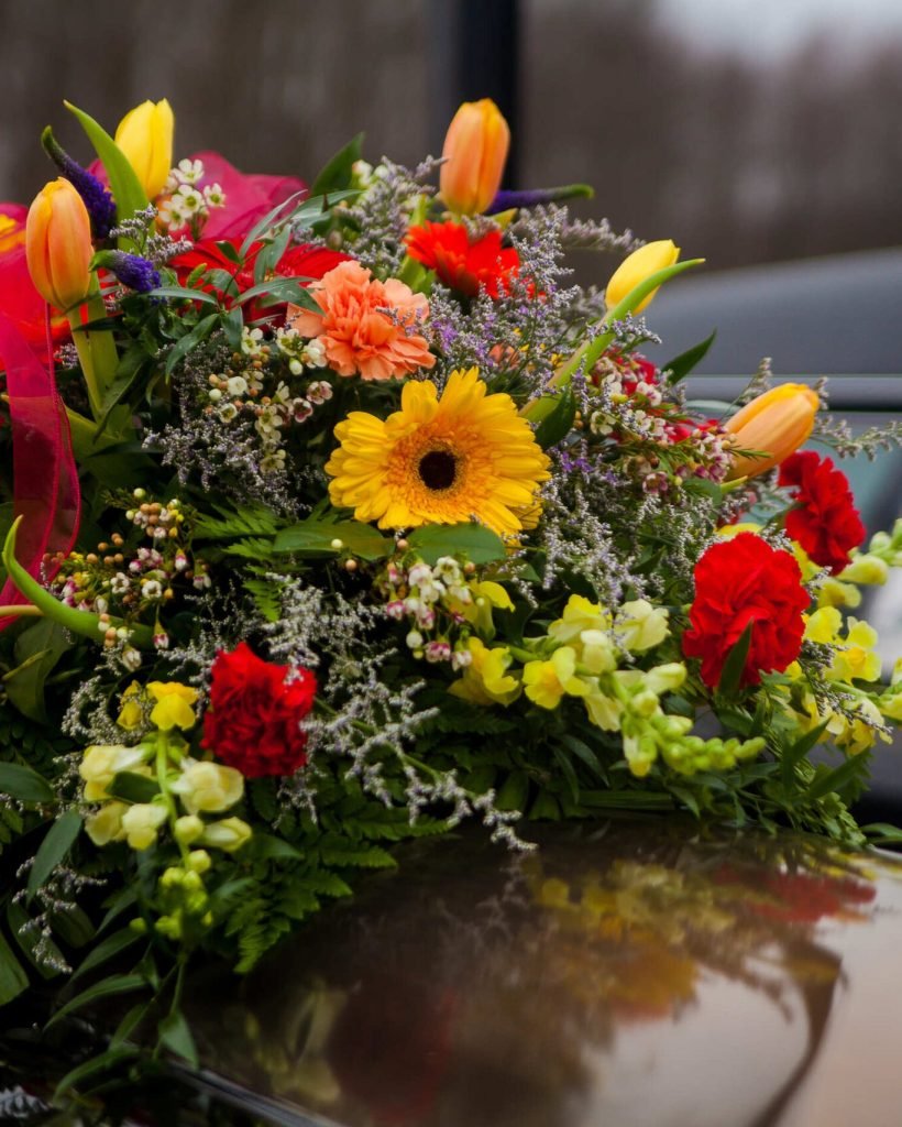 funeral-casket-and-flowers-next-to-hearse-2022-11-02-03-43-23-utc (1) (1)